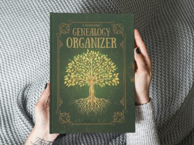 Home 2 A person in a teal sweater holding up the green 6-Generation Genealogy Organizer book against a plain grey studio background.